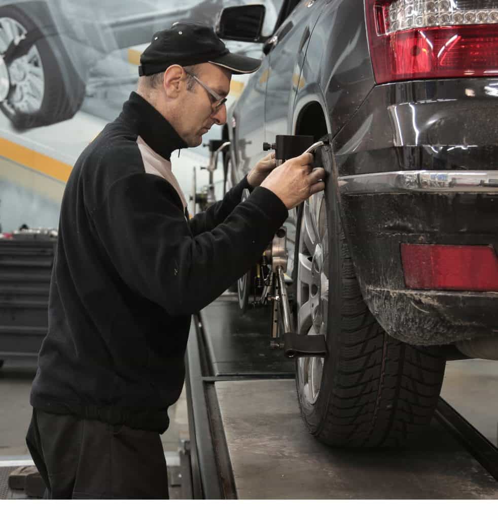 Man Adjusting Wheel Alignment